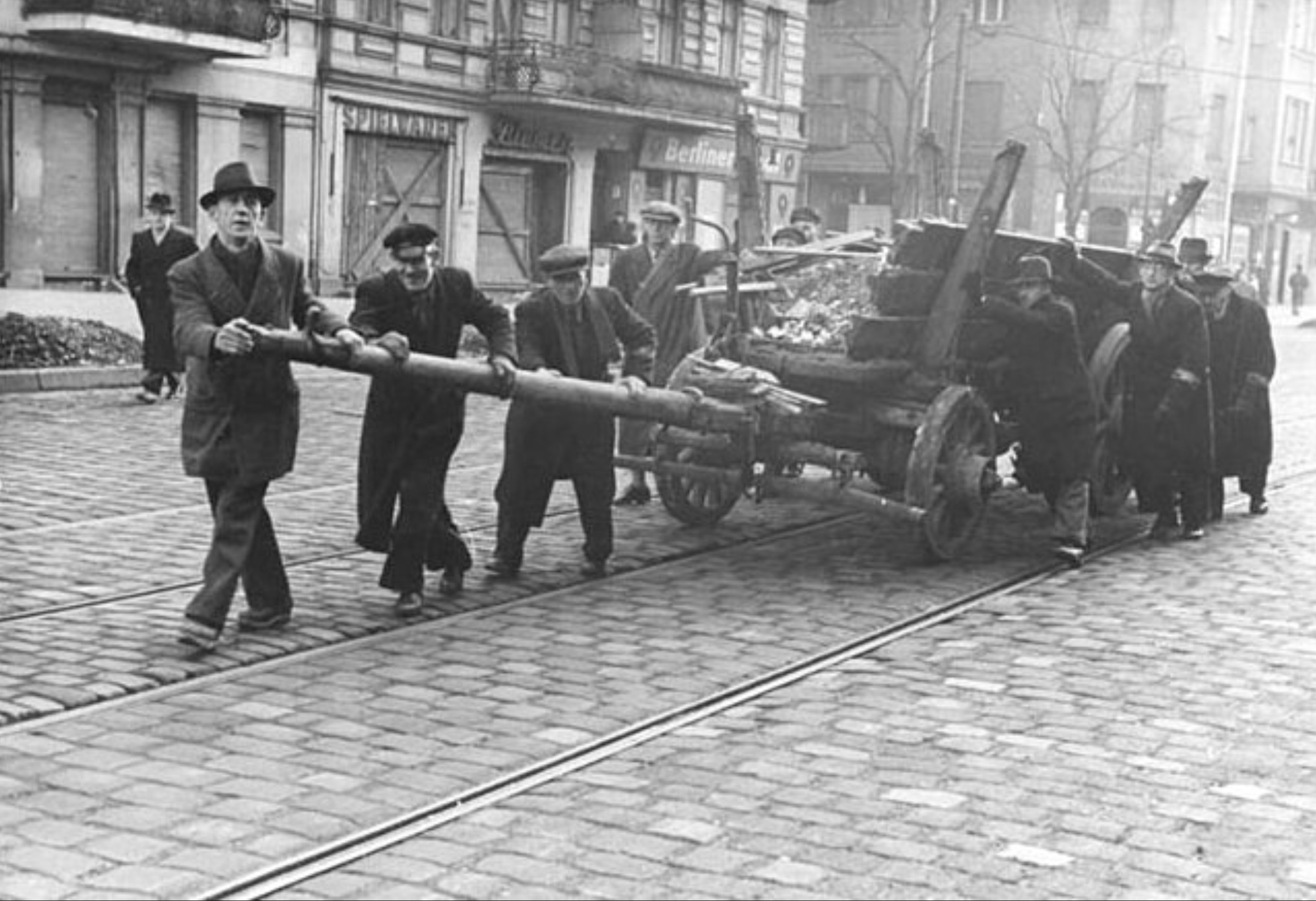 Volkssturm soldiers transport materials from bombed-out buildings for the construction of an anti-tank barrier. 